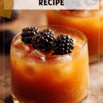 Two glasses stacked with apple cider and blackberries styled as spooky cocktails for Halloween 2